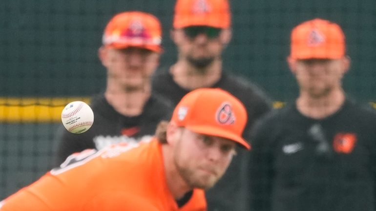 Baltimore Orioles pitcher Corbin Burnes throws during live batting practice...