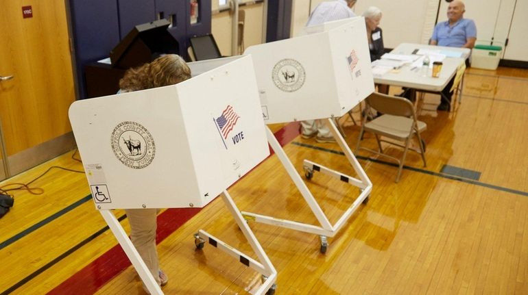 A woman casts her primary vote at a polling station...