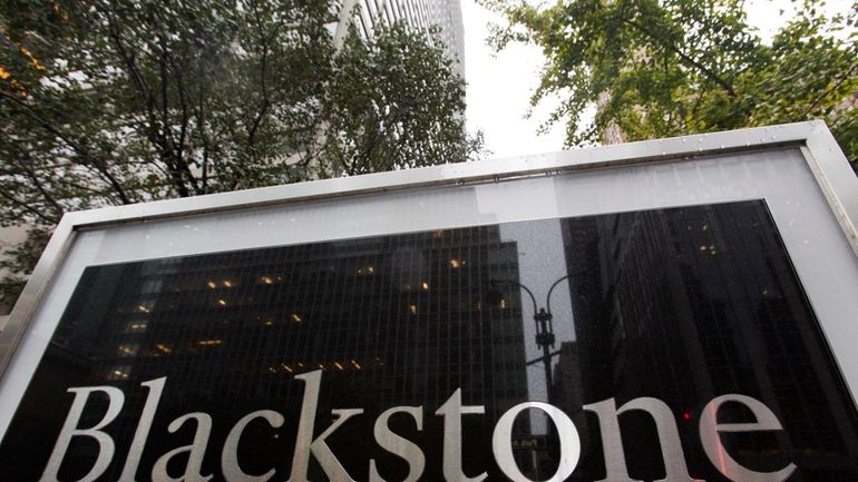 A sign for The Blackstone Group L.P. investment firm stands...