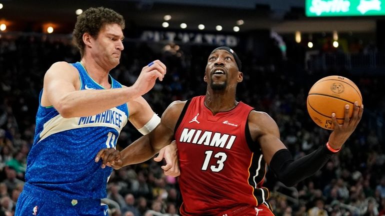 Miami Heat's Bam Adebayo (13) drives to the basket against...