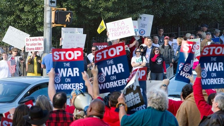 Protestors in support of Wisconsin Gov. Scott Walker, top, demonstrate...