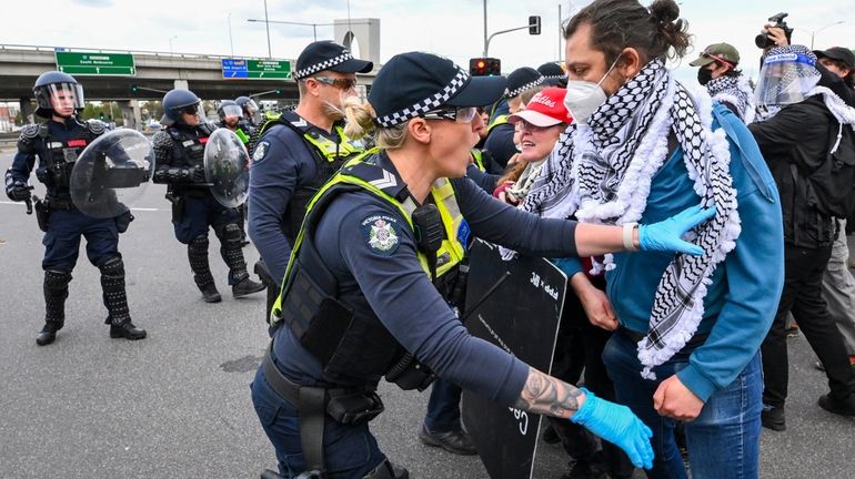 Victoria Police clash with anti-war protesters outside a military arms...