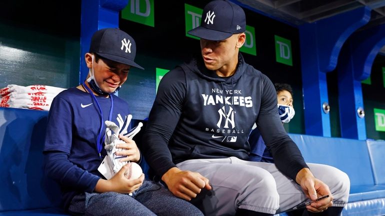 Fan Derek Rodriguez, 9, reacts while meeting Aaron Judge #99...