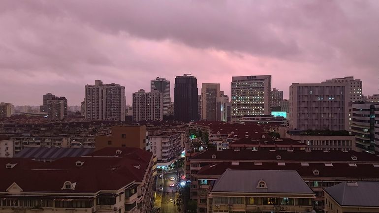 A view of pink cloudy skyline is seen in Shanghai,...