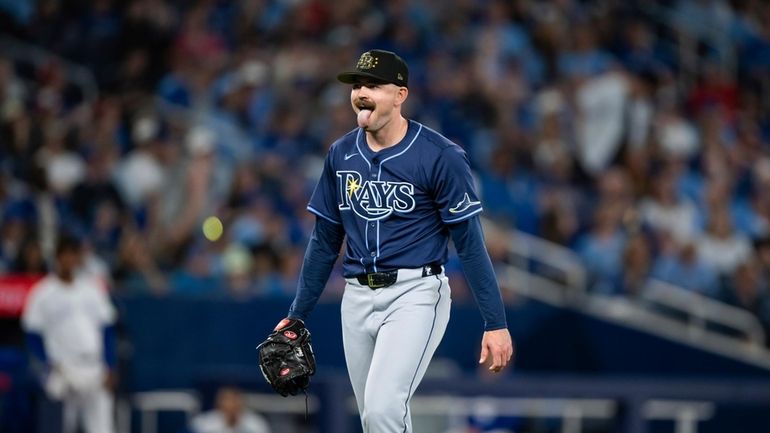 Tampa Bay Rays pitcher Tyler Alexander (14) reacts while walking...