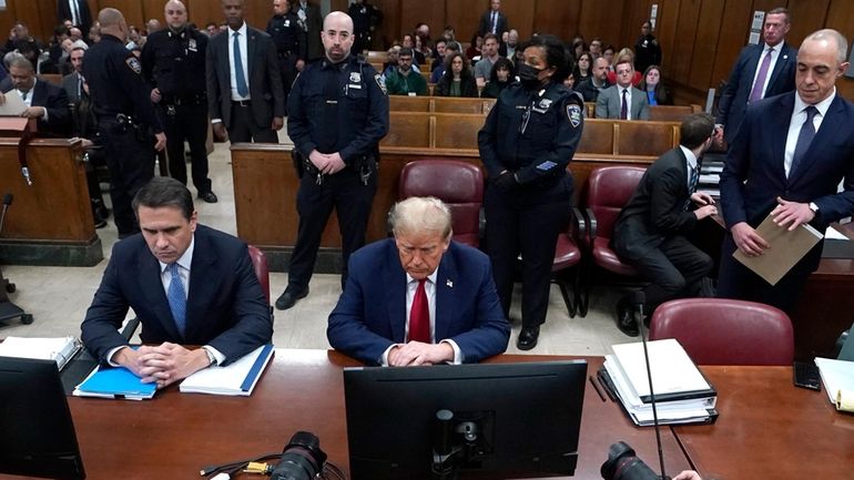 Former President Donald Trump, with lawyer Todd Blanche, left, attends...