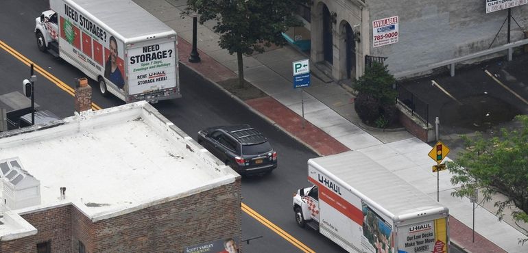 A moving van drives away from the governor's mansion in...