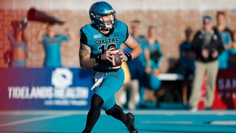 Coastal Carolina quarterback Ethan Vasko looks to pass against James...