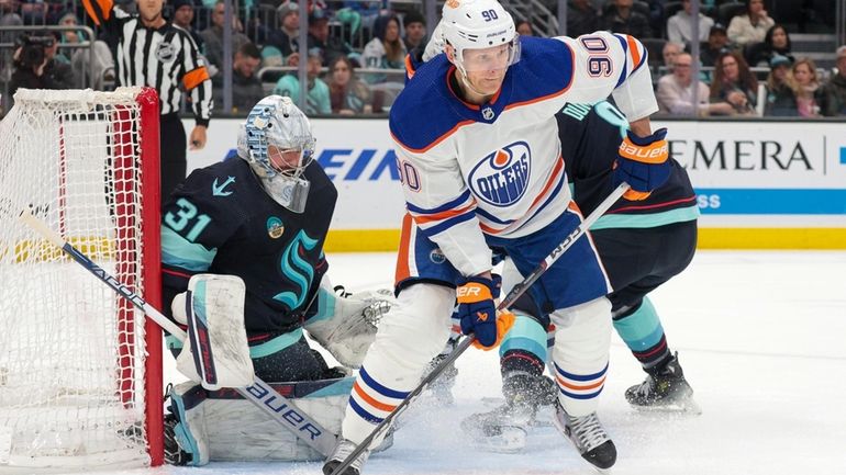 Edmonton Oilers right wing Corey Perry (90) moves the puck...