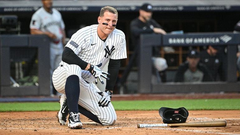 The Yankees’ Anthony Rizzo kneels after fouling a ball off his...