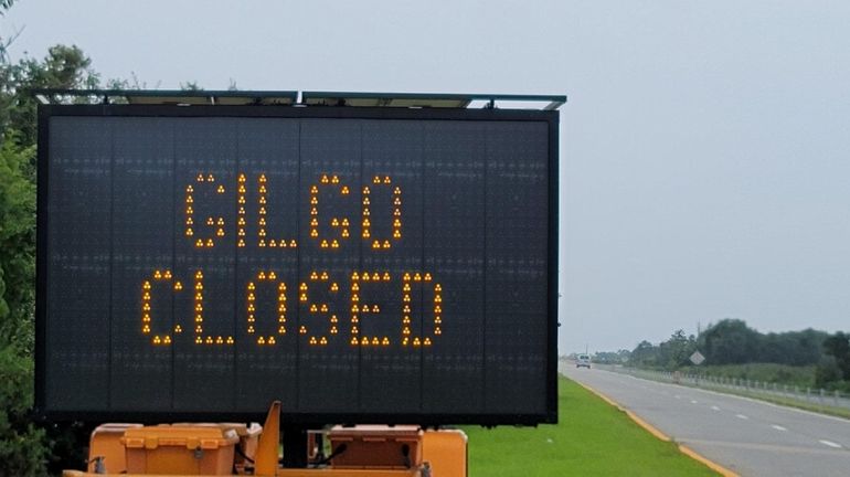 Sign on Ocean Parkway stating Gilgo State Park is closed.