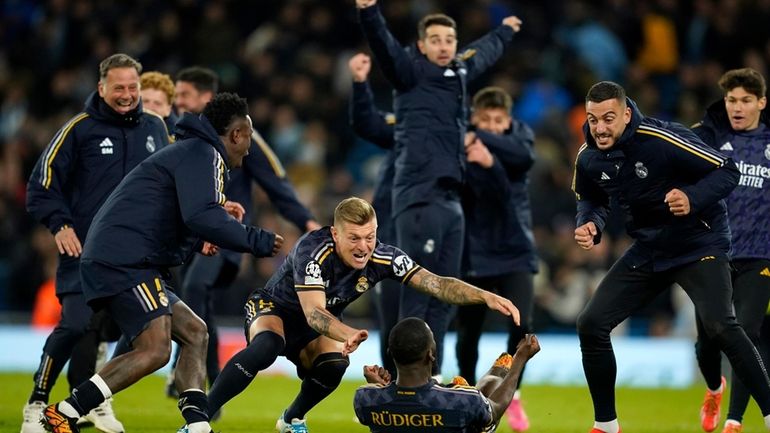 Real Madrid players celebrate after wining the Champions League quarterfinal...