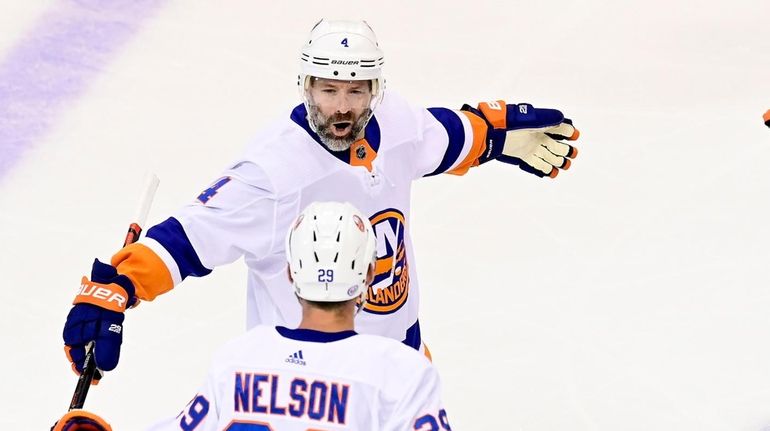 Islanders defenseman Andy Greene (4) celebrates his goal against the Philadelphia...