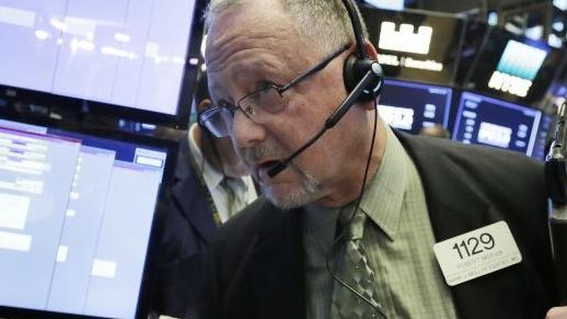 Trader Robert Moran works on the floor of the NYSE,...