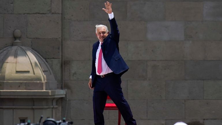 Outgoing President Andres Manuel Lopez Obrador waves after delivering his...