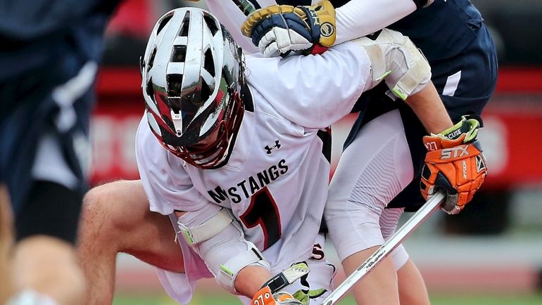 Mt. Sinai midfielder Jake Spallina wins the faceoff against Smithtown...