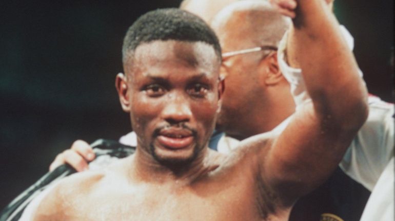 Pernell Whitaker has his hand raised in victory following his...