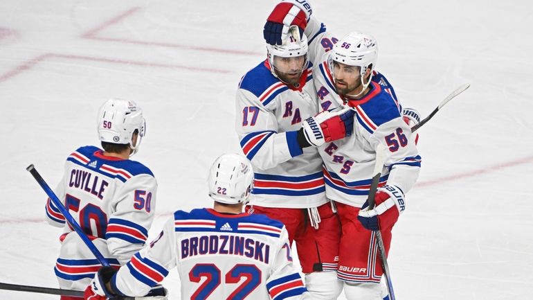 Rangers defenseman Erik Gustafsson (56) celebrates with right wing Blake...