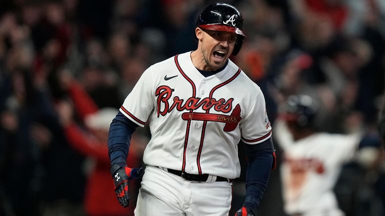 Atlanta Braves' Adam Duvall celebrates after his grand slam home...