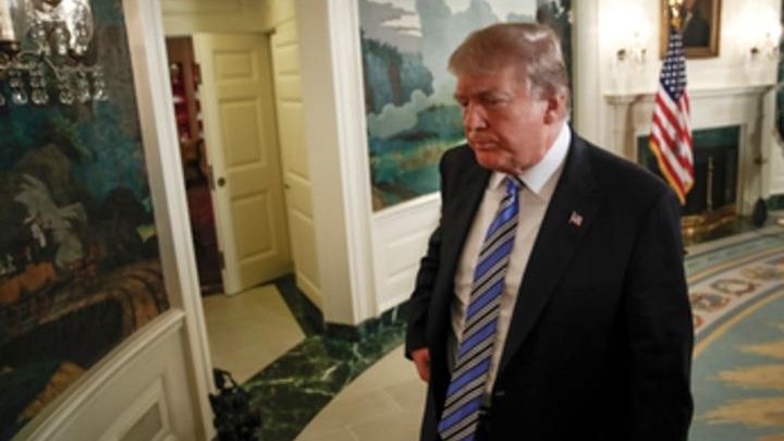 President Donald Trump walks off after delivering a statement on...