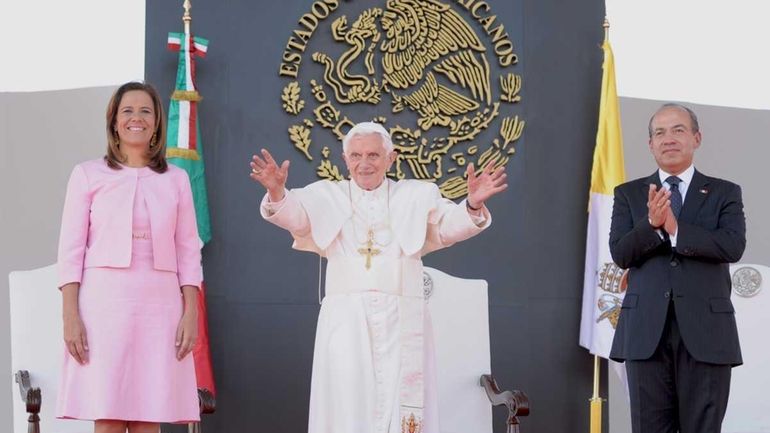 Pope Benedict XVI (C) is welcomed by Mexican President Felipe...