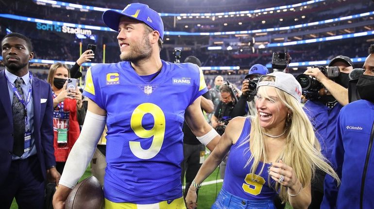 Matthew Stafford of the Rams and wife Kelly Hall react after...