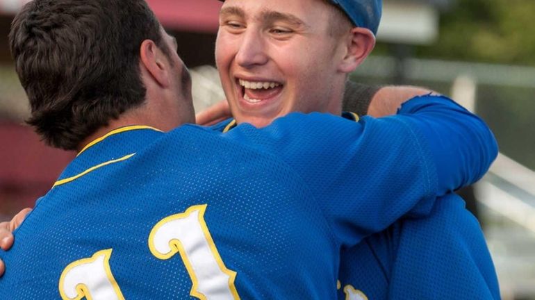 West Islip starting pitcher James Kory, right, gets a hug...