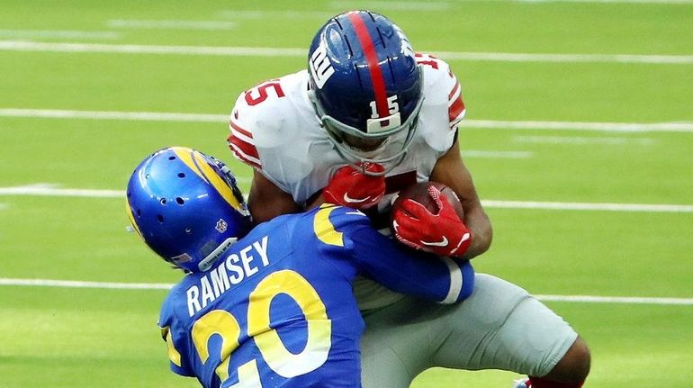 Jalen Ramsey of the Rams tackles Golden Tate of the Giants during the...