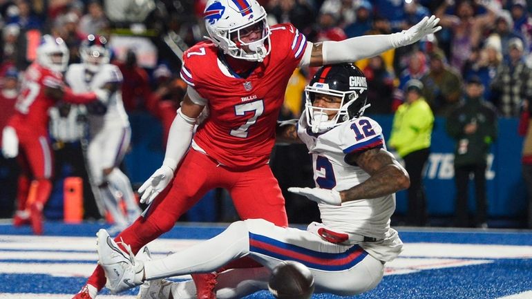 Buffalo Bills cornerback Taron Johnson breaks up a pass to New...