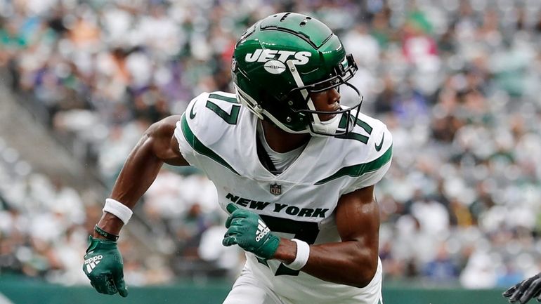 Garrett Wilson of the Jets runs a play against the Ravens at...