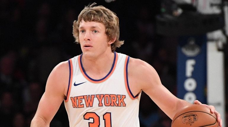 Knicks guard Ron Baker brings the ball up court against...
