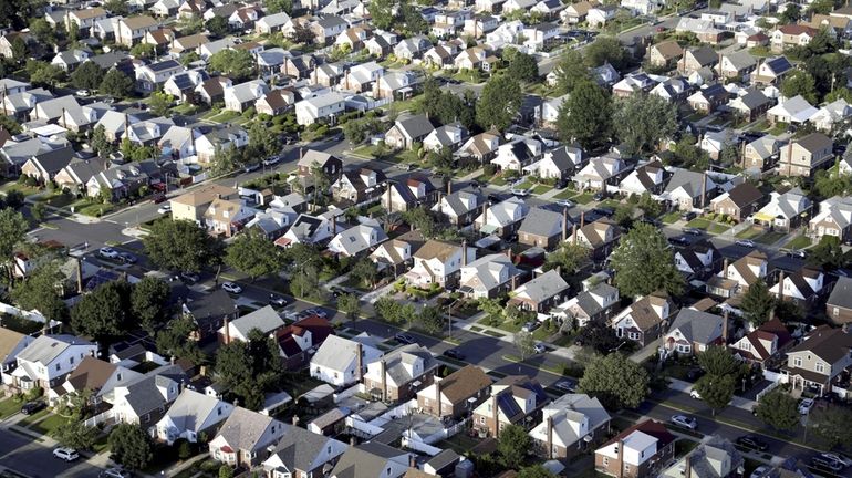 A neighborhood of houses in Elmont, NY is seen in...