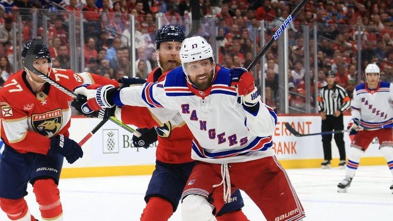 Blake Wheeler #17 of the Rangers is defended by Sam...