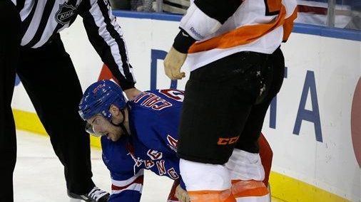 Linesman Pierre Racicot (65) holds Ryan Callahan after Callahan was...