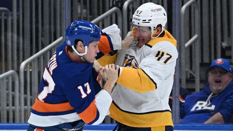 Islanders left wing Matt Martin fights with Predators right wing...