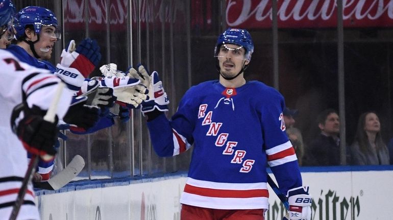 New York Rangers left wing Chris Kreider is congratulated by...