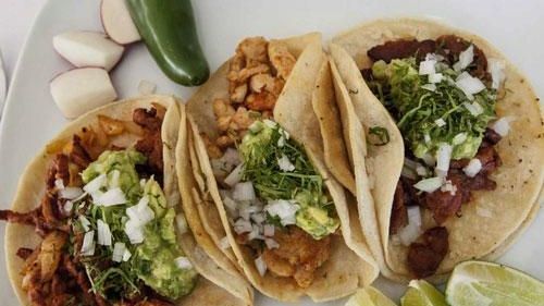 Tacos -- from left, pastor (pineapple-seasoned pork), pollo (chicken) and...