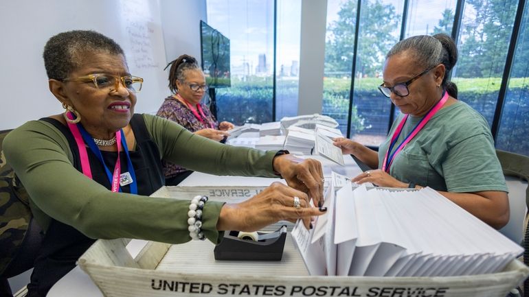 From left, Carol Hamilton, Cristo Carter and Cynthia Huntley prepare...