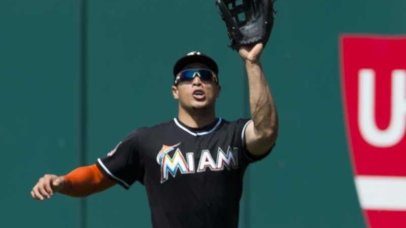 FILE - Clockwise from top left are 2017 file photos showing: Miami Marlins' Giancarlo  Stanton hitting a two-run home run during the third inning against the  Washington Nationals in Washington; Giancarlo Stanton