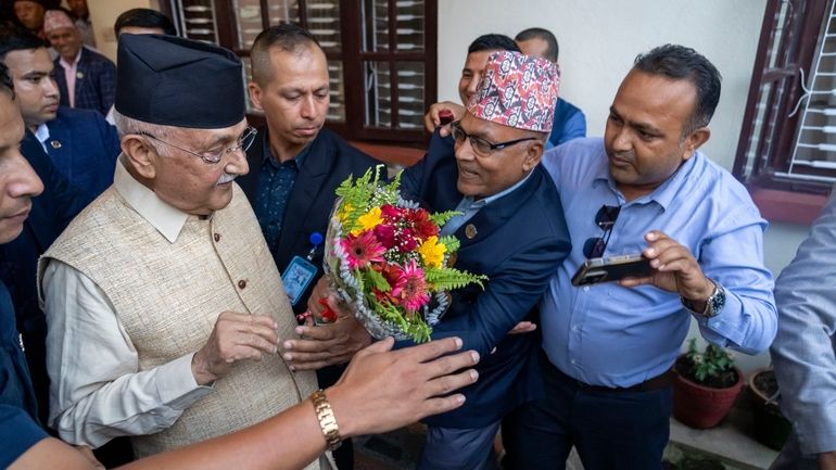 Khadga Prasad Oli, left, the chairman of the Communist Party...