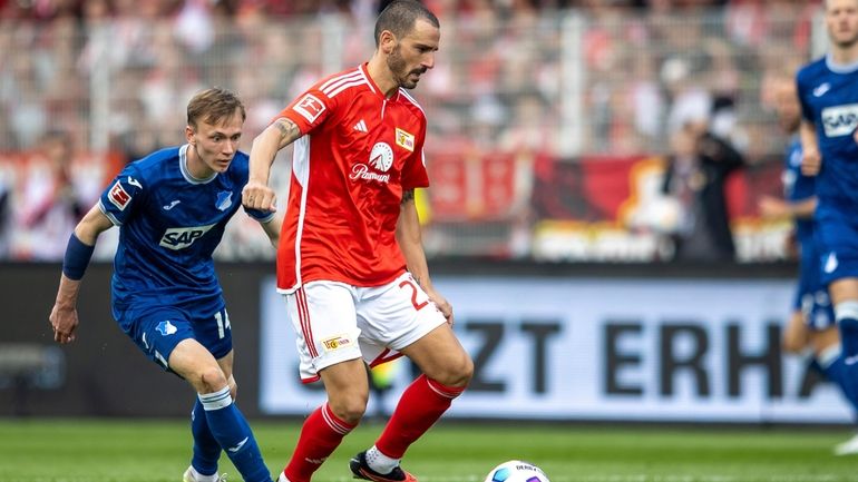 Hoffenheim's Maximilian Beier, left, challenges Berlin's Leonardo Bonucci during the...