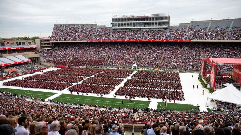 Attendees watch the 170th University of Wisconsin-Madison commencement ceremony at...