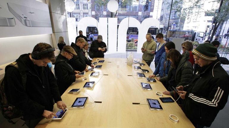 Shoppers check out the new Apple iPad mini at the...