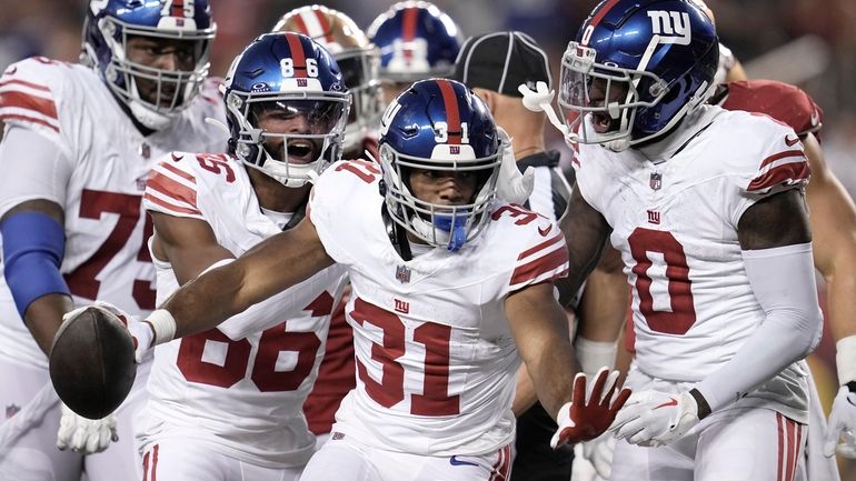 Giants running back Matt Breida (31) is congratulated by teammates...