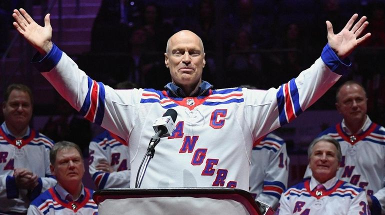 Former Rangers captain Mark Messier gestures to fans during the...