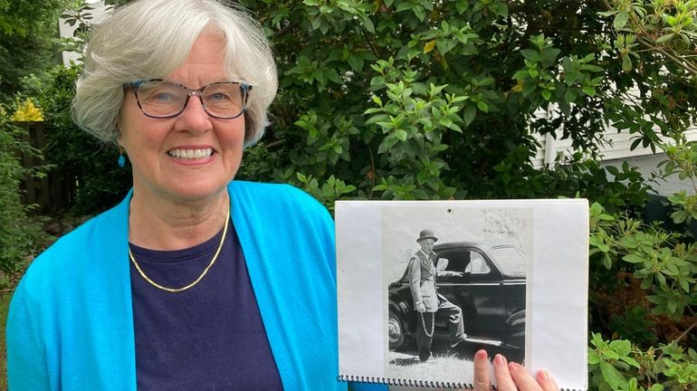 Janet Clement holding a family photograph, taken about 1942, of...