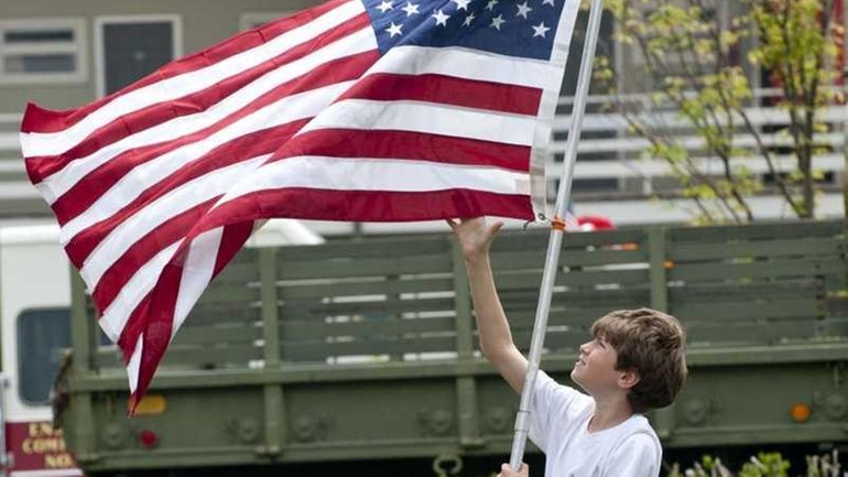 A young boy with an American Flag at the end...