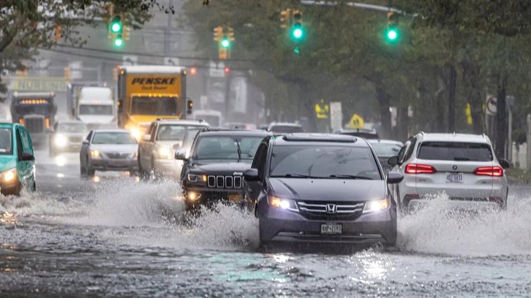 Motorists driving north and south on Peninsula Boulevard negotiate their...