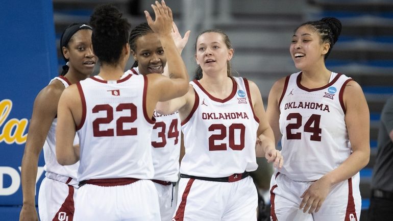 Oklahoma players celebrate a basket by guard Aubrey Joens (20)...