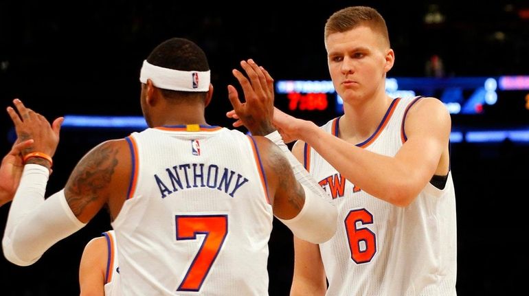 The Knicks' Kristaps Porzingis and Carmelo Anthony celebrate after a...